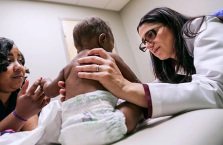 a doctor examines a child