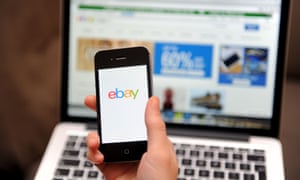 eBay on a smartphone and laptop