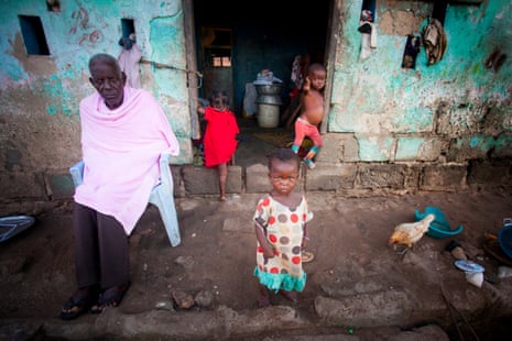 A family outside their home in the fishing village of Nyanyano