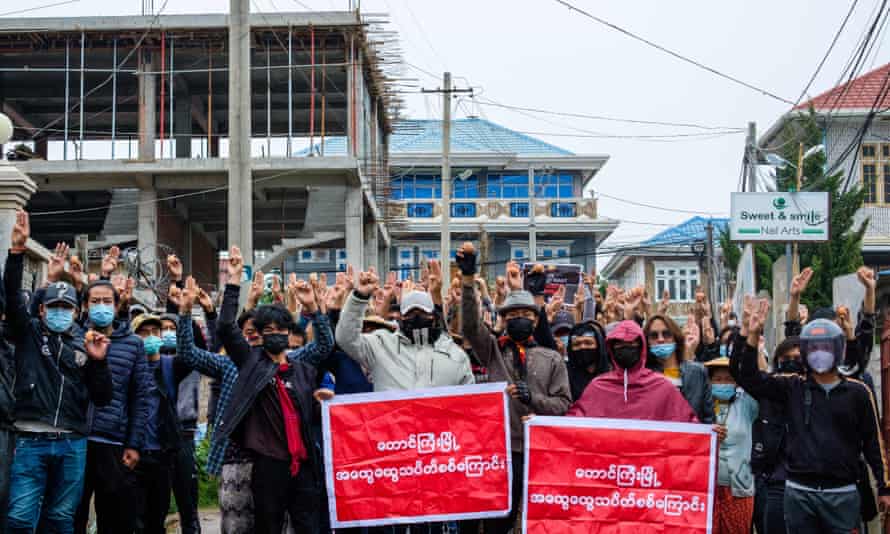 Protesters in Taunggyi hold up Easter eggs and make the three-finger salute during a demonstration against the military coup.