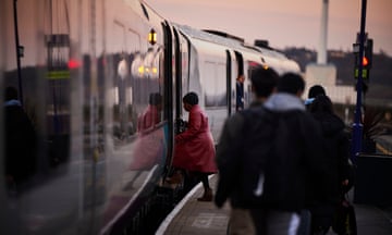 Passengers board a train at Huddersfield railway station