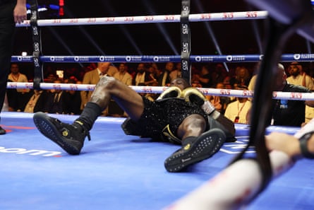 Deontay Wilder looks up from the canvas after getting knocked down by Zhilei Zhang early Sunday morning in Riyadh.