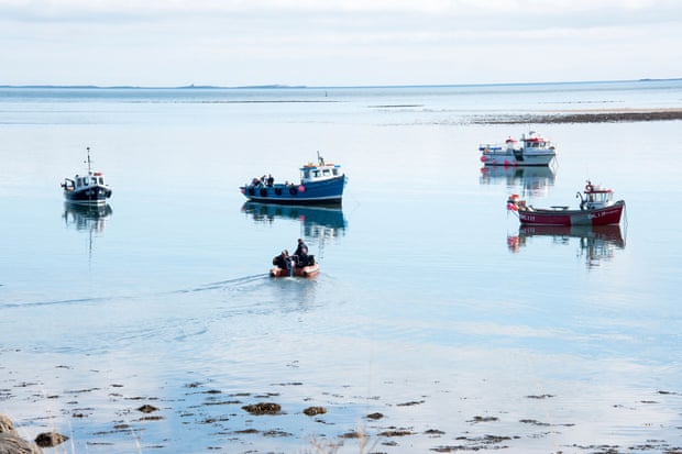 Fishing boats moored near Lindisfarne's harbor.