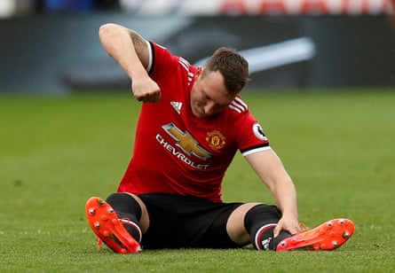 Phil Jones punches the floor in frustration after suffering an injury which turned out to be pivotal in the game.
