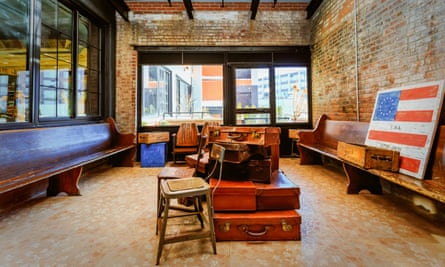 Paper Factory, NYC hotel, with Americana signs and old suitcases in a communal area.