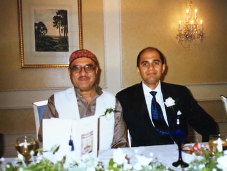 Sajid Javid in a dark suit and white shirt with sitting with his father at his wedding table.