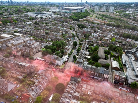 An aerial view shows Arsenal supporters filling the streets, with the old Highbury and the Emirates Stadium in the background