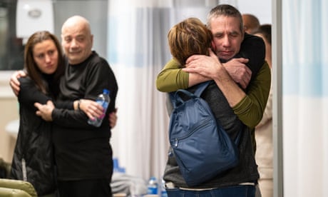 Norberto Louis Har (2-L) and Fernando Simon Marman (R), two Israeli men freed during an Israeli operation in southern Gaza, being reunited with their families at Sheba Medical Center in Tel Hashomer, Israel.
