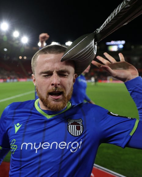 Fish slap: Grimsby's defender Niall Maher is hit by an inflatable fish as he celebrates after Gavan Holohan scores the team's second goal.