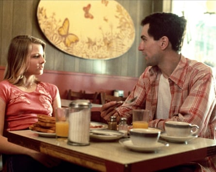 A man and girl talking at a diner