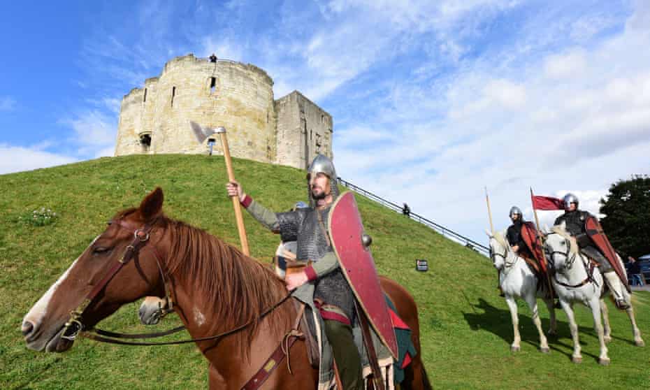 Members of King Harold’s army ride past Clifford’s Tower in York