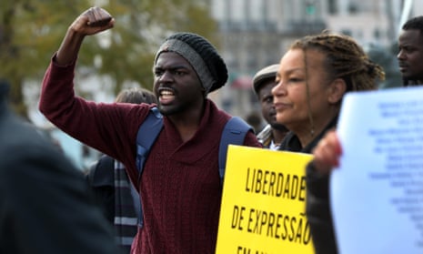 Demonstrators shout slogans and hold placards saying ‘Expression of freedom in Angola’ in March. 
