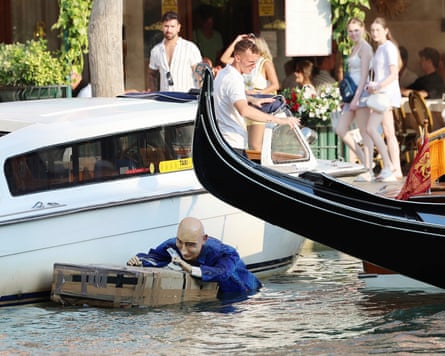 A Jeff Bezos dummy floats in a Venice canal.