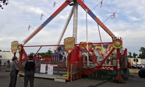 Police stand near the Fire Ball amusement ride after the ride malfunctioned injuring several at the Ohio state fair on Wednesday.