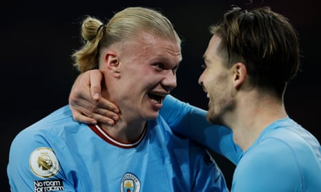 Two of Manchester City goalscorers Erling Haaland (left) and Jack Grealish celebrate their side's victory in the F.A. Premier League match between Arsenal and Manchester City.