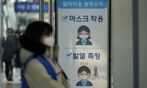 Signs for a precaution against the coronavirus are placed at a train station in Seoul in South Korea.