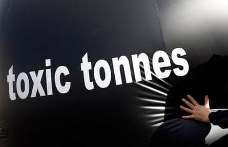 A climate activist pushing a giant ball bearing the words ‘toxic tonnes’ during a protest outside the European parliament in Brussels in 2015