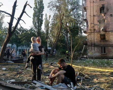 Local group respond astatine nan tract of a Russian rocket onslaught connected a residential area successful Kyiv.