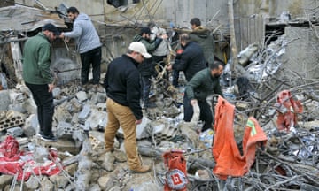 People inspect rubble.