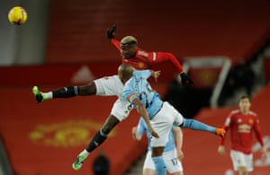Paul Pogba and Fernandinho challenge for a header.
