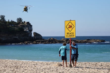 Lifeguards erect a sign that says “Beach Closed” following a shark attack at Coogee beach in Sydney