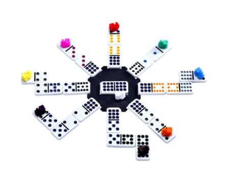 Mexican Train dominoes radiate from a central hub, each row topped with a coloured train marker