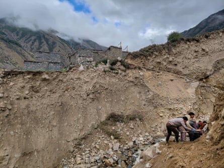 People clearing stones off the mountainside
