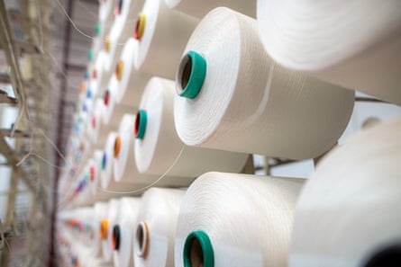 Textile yarn manufacturing, synthetic yarn, polyester and polypropylene production stages, yarn wound as bobbins.