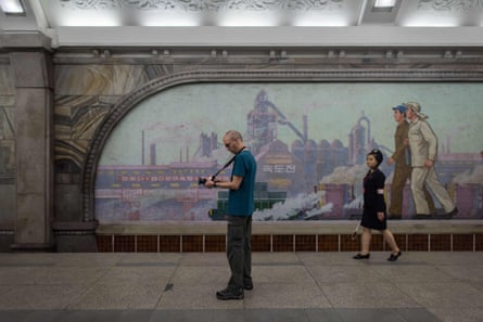 A tourist takes a photo during a visit to a subway station in Pyongyang in 2017.