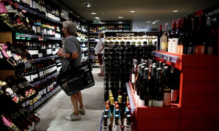 A customer browses bottles of wine for sale inside a Monoprix supermarket operated by Casino Group, in Paris