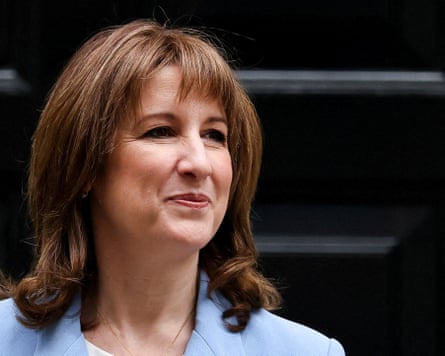 Rachel Reeves, in a light blue blazer, looks to the side outside Downing Street