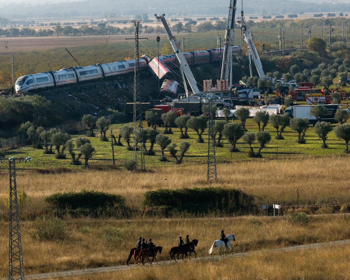 A crane at the scene of a train crash. One of the pictured train’s carriages has left the tracks.