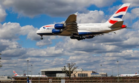 A British Airways Airbus A380 airplane on final approach flying over the houses in Myrtle Avenue, arriving for landing in London Heathrow Airport.