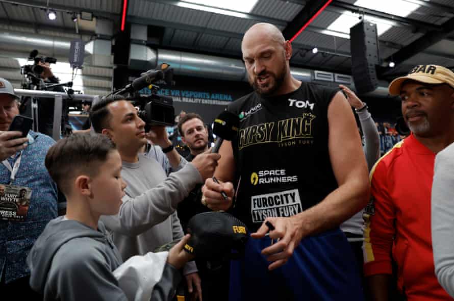 Tyson Fury gives interviews and signs autographs after the weigh in.