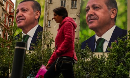 A person walks past billboards of Recep Tayyip Erdogan in Istanbul