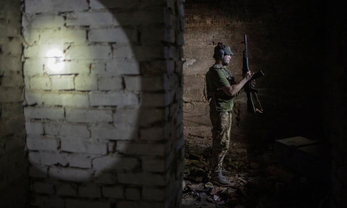 Artem, a member of the Carpathian Sich battalion, stands in a basement bunker at the frontline in Kharkiv, Ukraine.