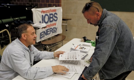 A recruiter in the shale gas industry, left, speaks with an attendee of a job fair in Cheswick, Pennsylvania.