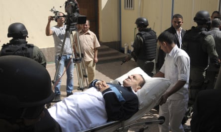 Mubarak being taken into the Cairo courtroom on a gurney in September 2011.