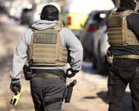 Federal agents wearing bulletproof vests.