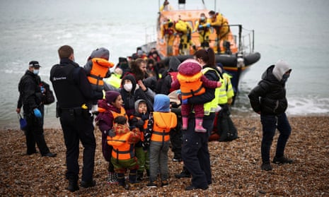 Migrants are brought ashore by RNLI staff, police officers and Border Force staff, in Dungeness, Kent, on 24 November 2021.