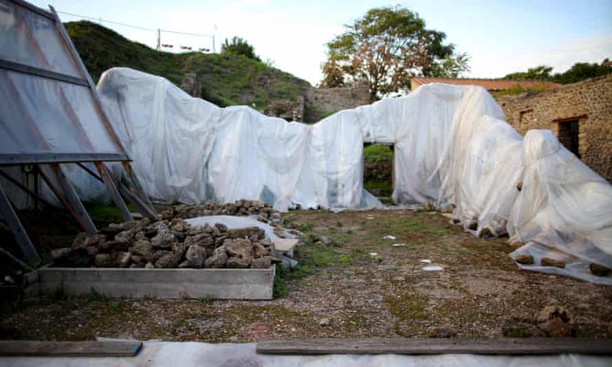 Plastic sheets cover the remains of a house at the UNESCO World Heritage site of Pompeii, October 13, 2015.