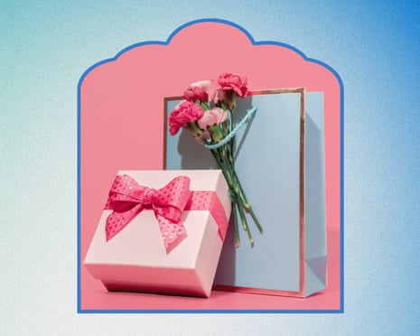 A gift bag with flowers and a gift box with a bow
