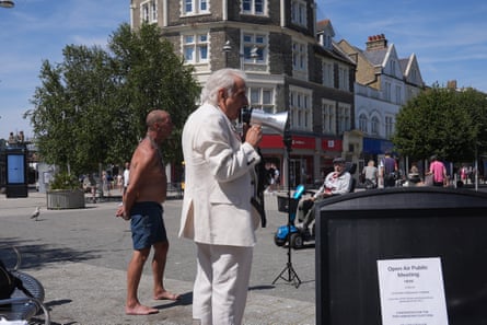 Erlam speaks into a megaphone in the town square of Clacton.