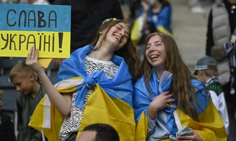 Two fans celebrate with a placard saying ‘Glory for Ukraine’ in Ukrainian during the national team’s friendly against Borussia Mönchengladbach