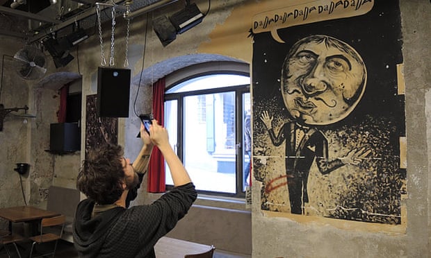 Man taking photos inside Cabaret Voltaire.