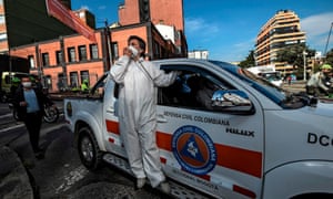 Mayor Claudia Lopez wears a protective suit as she uses a megaphone to speak in an area of Bogota declared under orange alert, in May, 2020.