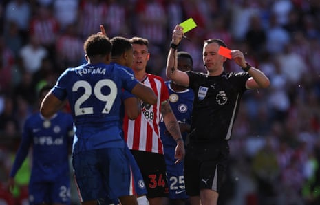 Referee Chris Kavanagh shows Wesley Fofana of Chelsea a second yellow card