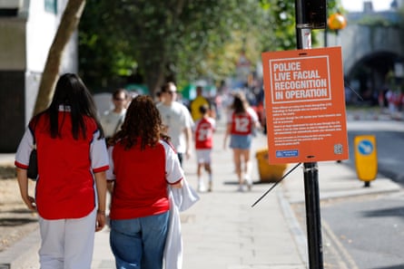Arsenal fans walk down Hornsey Road on their way to the ground past live facial recognition cameras.