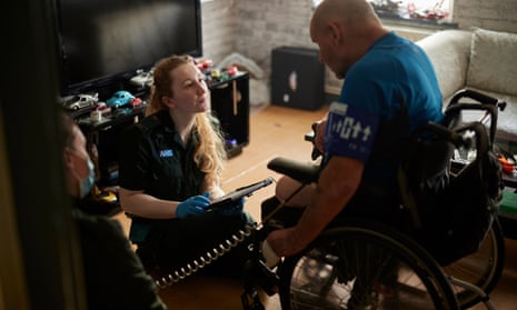 Laura Brown (left) and Jennifer Nelson help Malcolm Harvey after responding to an emergency callout in Catford, south London.