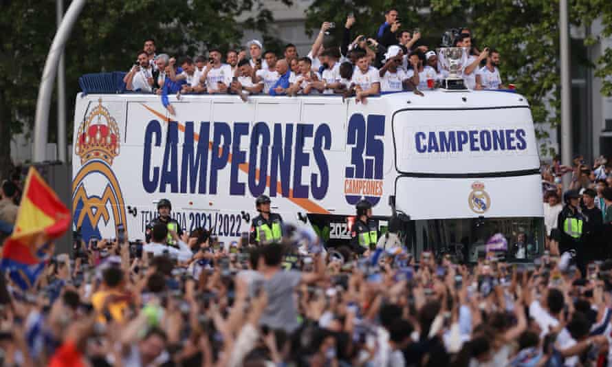 Fans salute Real Madrid in their victory parade at Plaza de Cibeles.